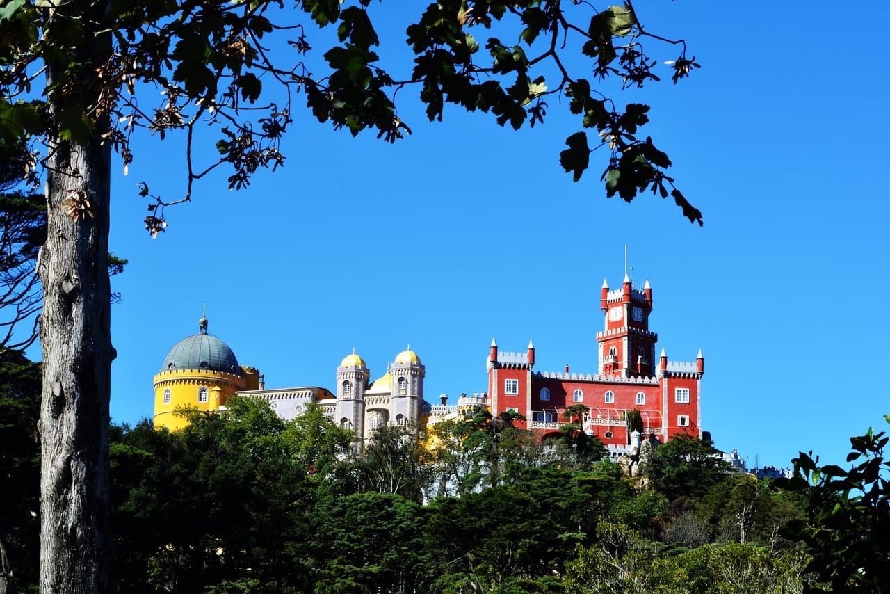 The Pena Palace, painted yellow and red, on top of the hill above Sintra.